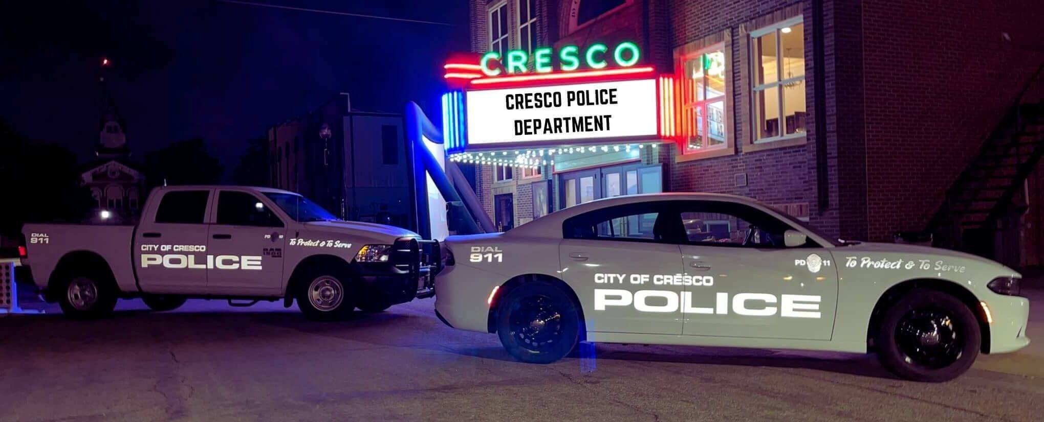 Cresco Police Vehicles outside of opera house at night